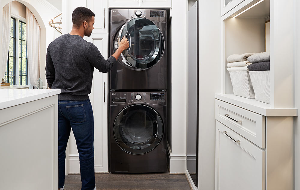 Person in front of stacked washer and dryer