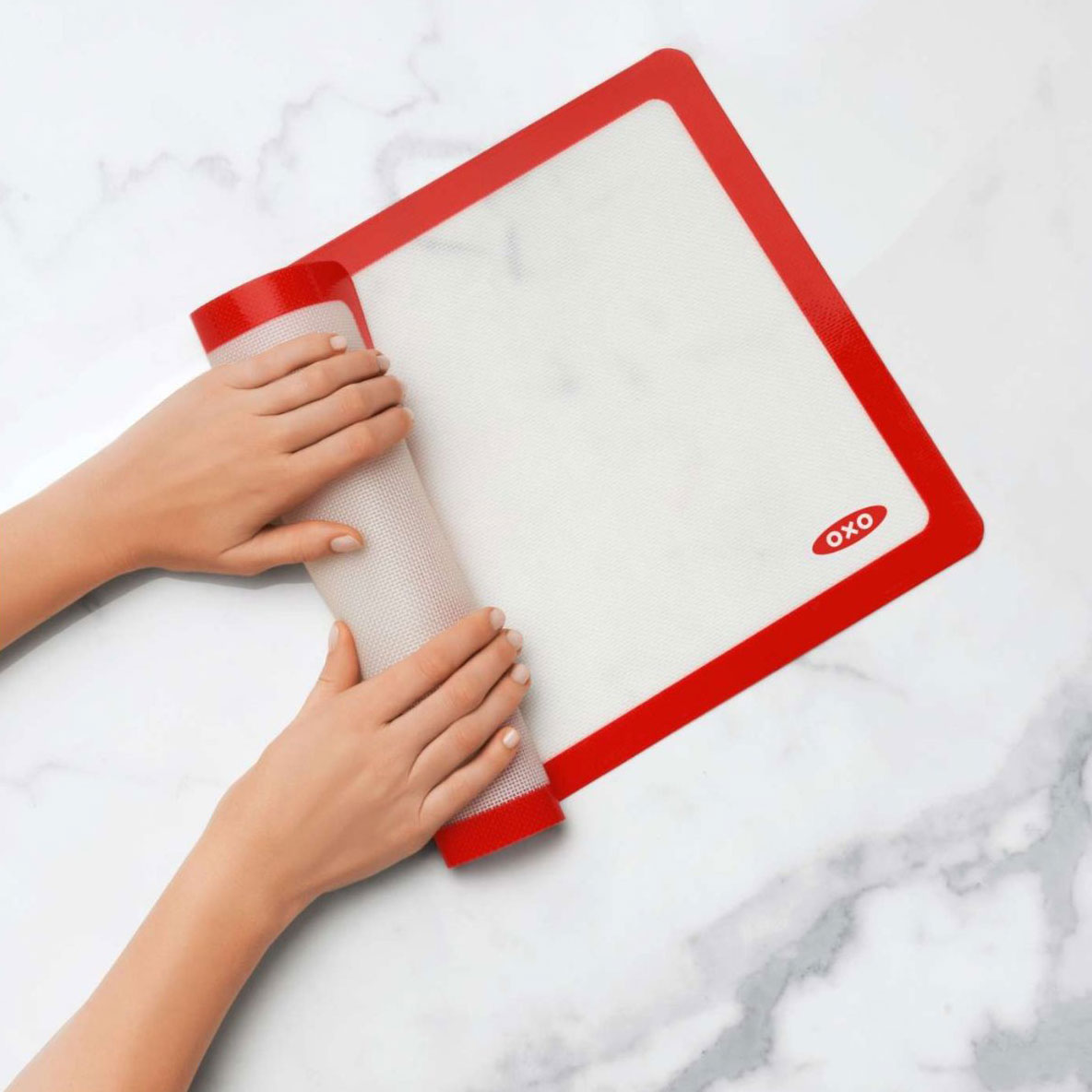 View of Person Rolling Up OXO Baking Mat