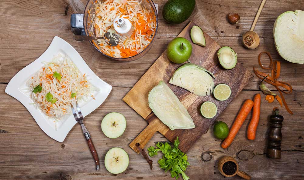 Overhead view of food preparation with vegetables