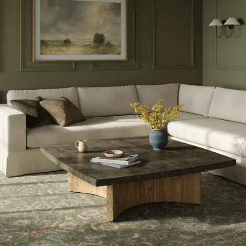 A stylish living room showcasing a white couch paired with a wooden table, emphasizing modern decor