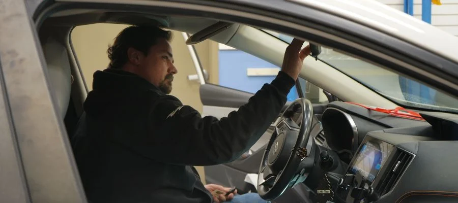 Gary Allen working inside a car in the mobile install studio