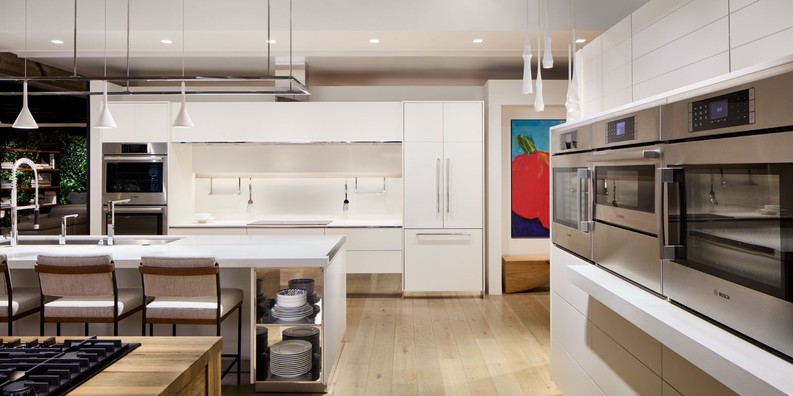 A stylish kitchen in a Thermador showroom, highlighting a high-end stove alongside a beautifully designed sink area
