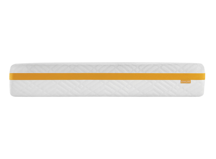 Close-up of mattress edge with orange stripe and quilted top, showing internal layers label blocks