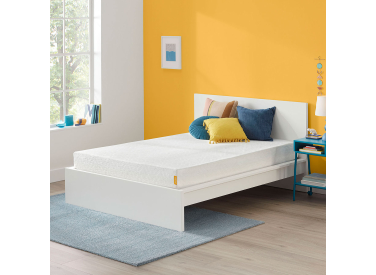 Close-up of mattress surface with slight compression, illustrating softness and quilted top.
