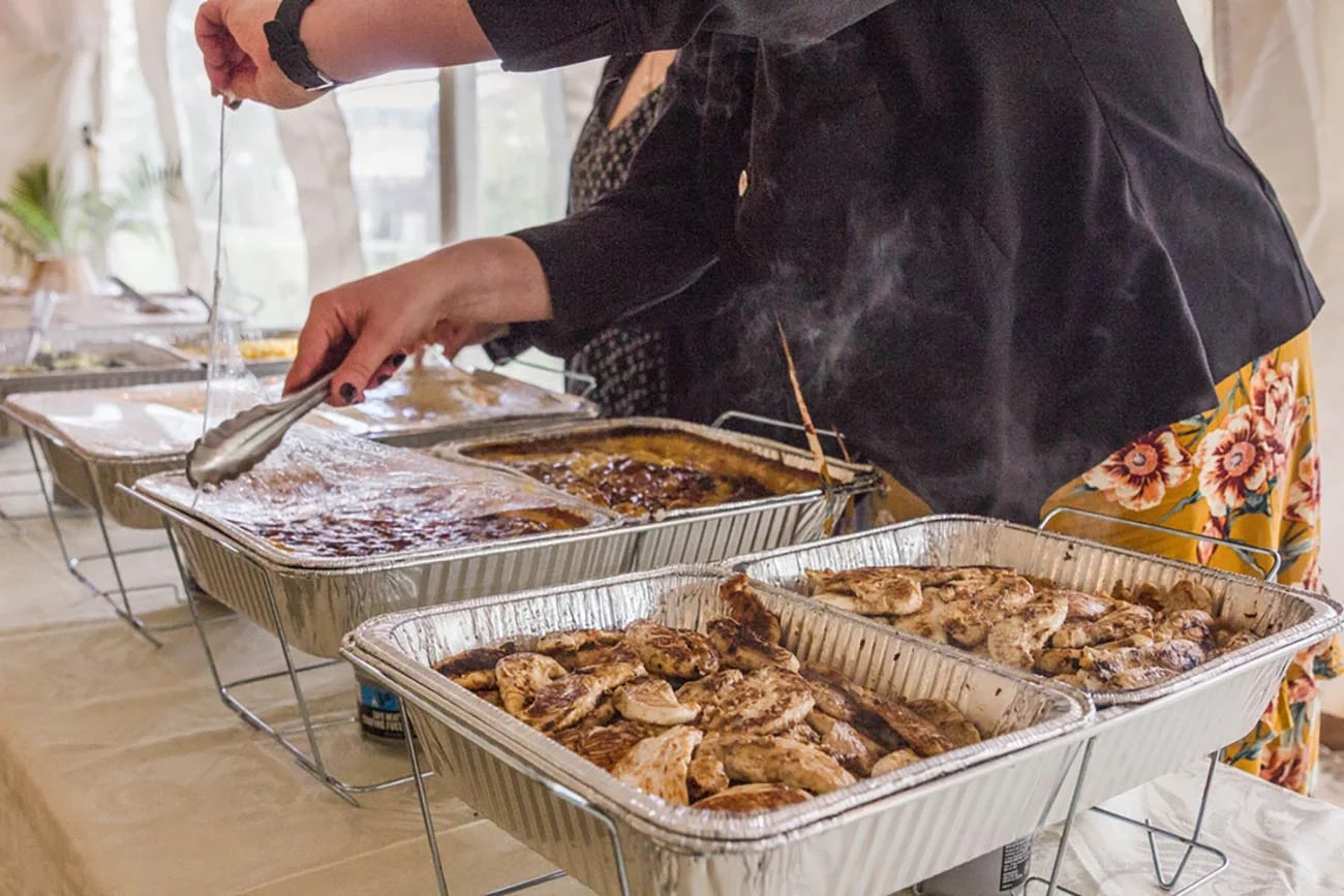 food in foil trays set up buffet-style