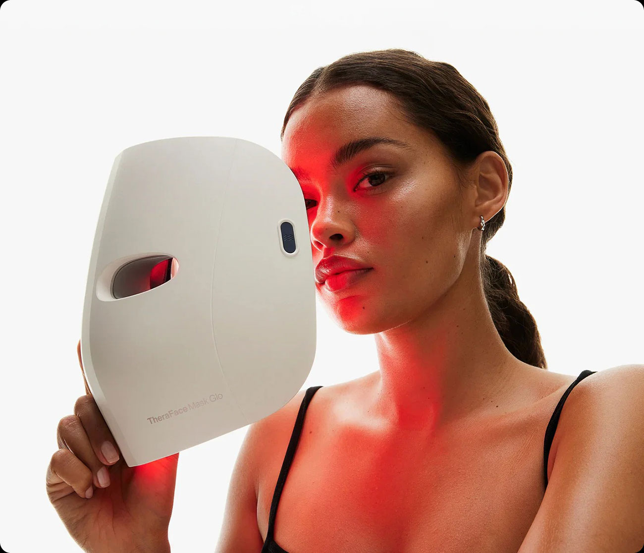 Woman Holding the Therabody Therapy Mask While Standing