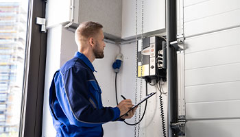 Technician testing near control panel