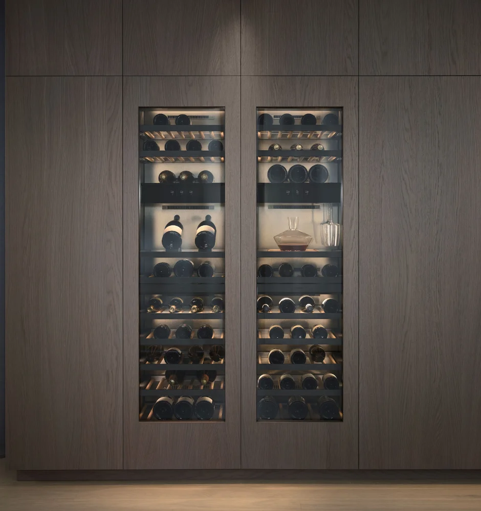A stylish kitchen with wooden walls displaying a Gaggenau built-in wine refrigerator for optimal wine storage