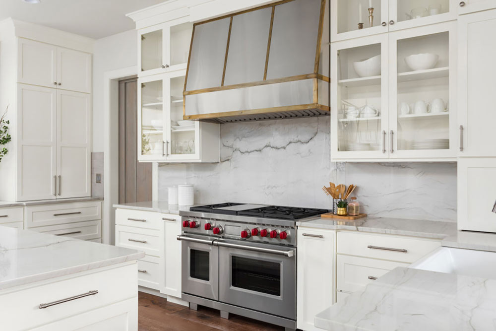 Kitchen with gas grill and oven hood