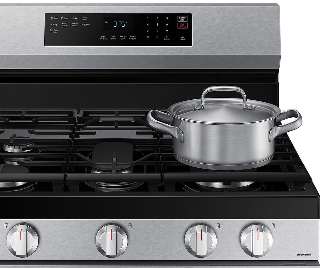 Front corner view of cooktop with pot on front right burner