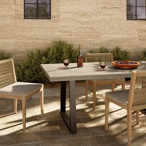 A table with chairs and a bottle of wine on an outdoor patio
