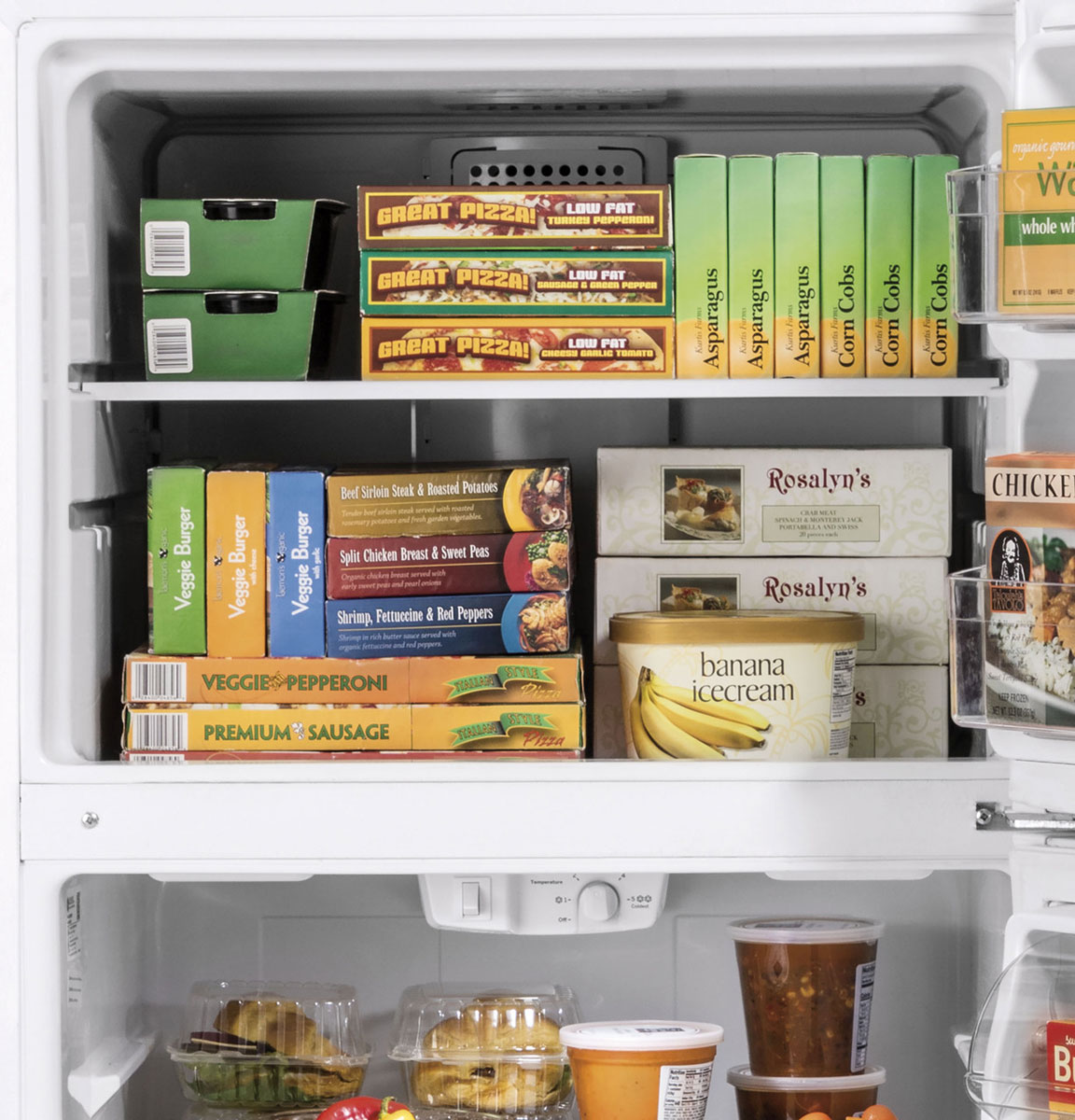 Close-up of freezer filled with frozen foods.