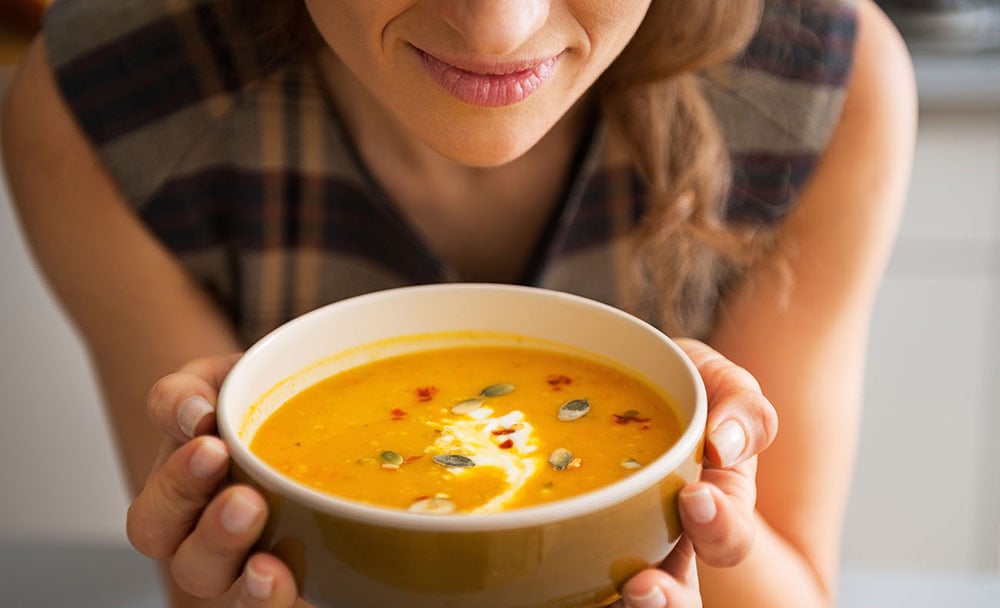 Gril with reheated bowl of soup in her hands