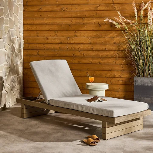 An outdoor rustic wall complimented by a wooden patio bench
