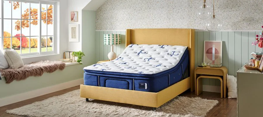 A Stearns & Foster mattress on a wooden bed frame in a pastel themed bedroom