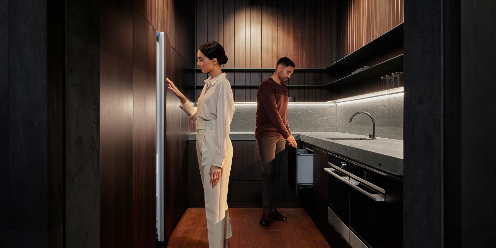 A contemporary Gaggenau refrigerator with a glass door ajar, revealing its stylish interior and advanced features