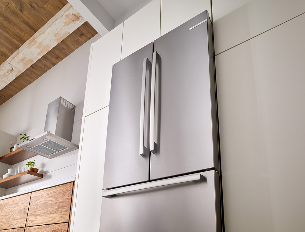 Top of a Bosch 800 Series 36 Inch Counter-Depth Refrigerator in a White and Oak Kitchen
