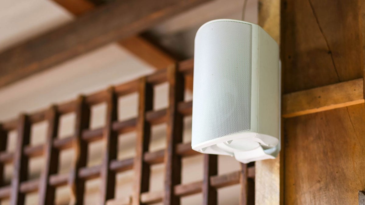 White Speaker Mounted to Exterior of Brown House
