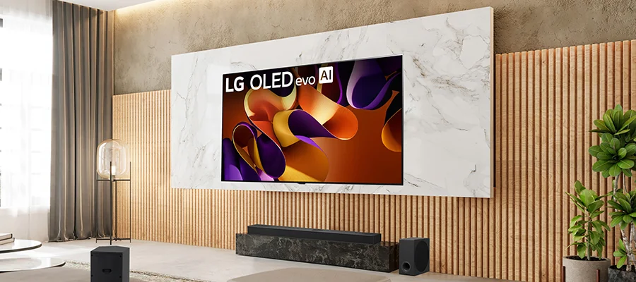 The LG S95TR soundbar sitting on a marble TV stand beneath a wall-mounted LG OLED evo AI TV.