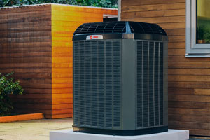 A black Trane central air conditioner