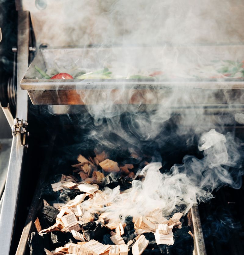 Close-up of a person opening a Sub-Zero refrigerator, showcasing a detailed vegetable and fruit drawer