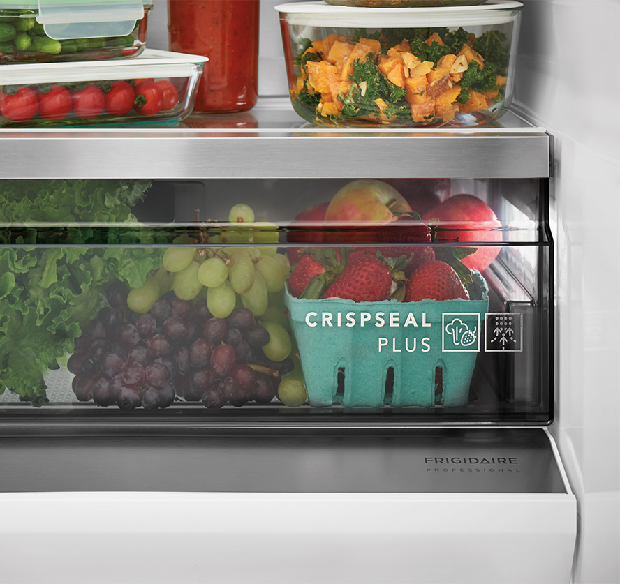Close-up Frigidaire Professional Crisp Seal Plus technology and logo, showcasing a detailed vegetable and fruit drawer