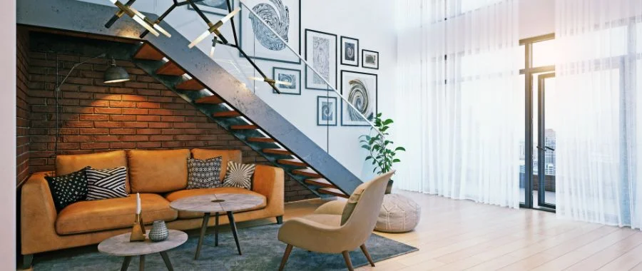 The interior of an apartment with a brown leather couch, photo wall and glass doors