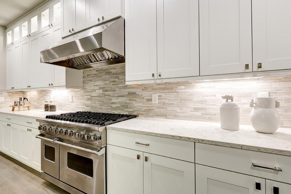 Side view of kitchen with gas grill and counter tops