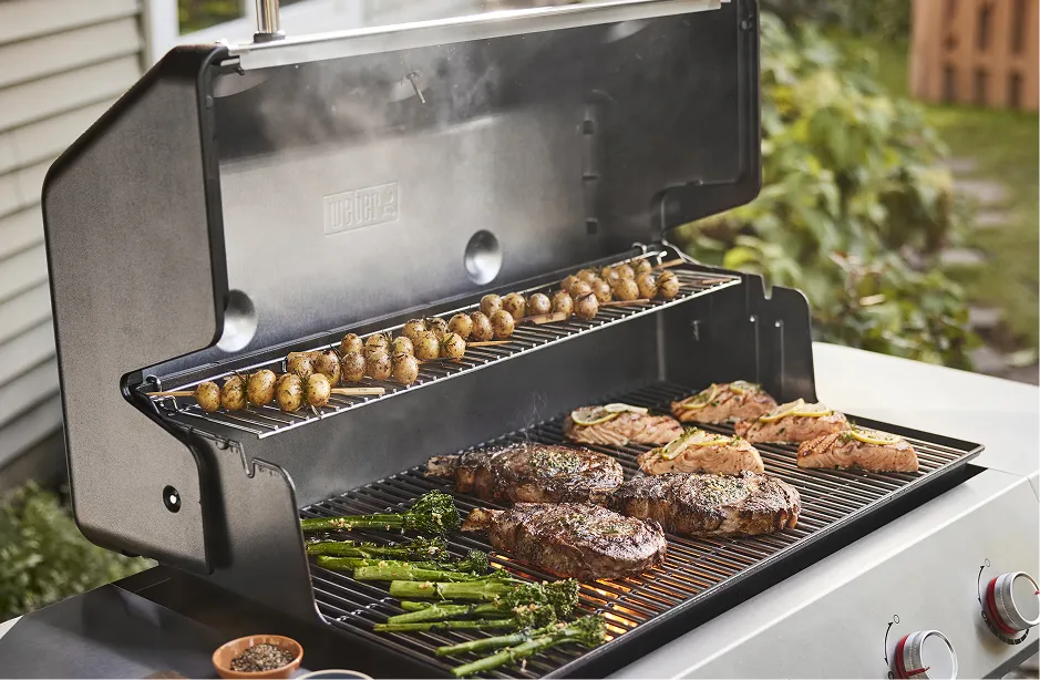 Skewers cooking on a smoky grill