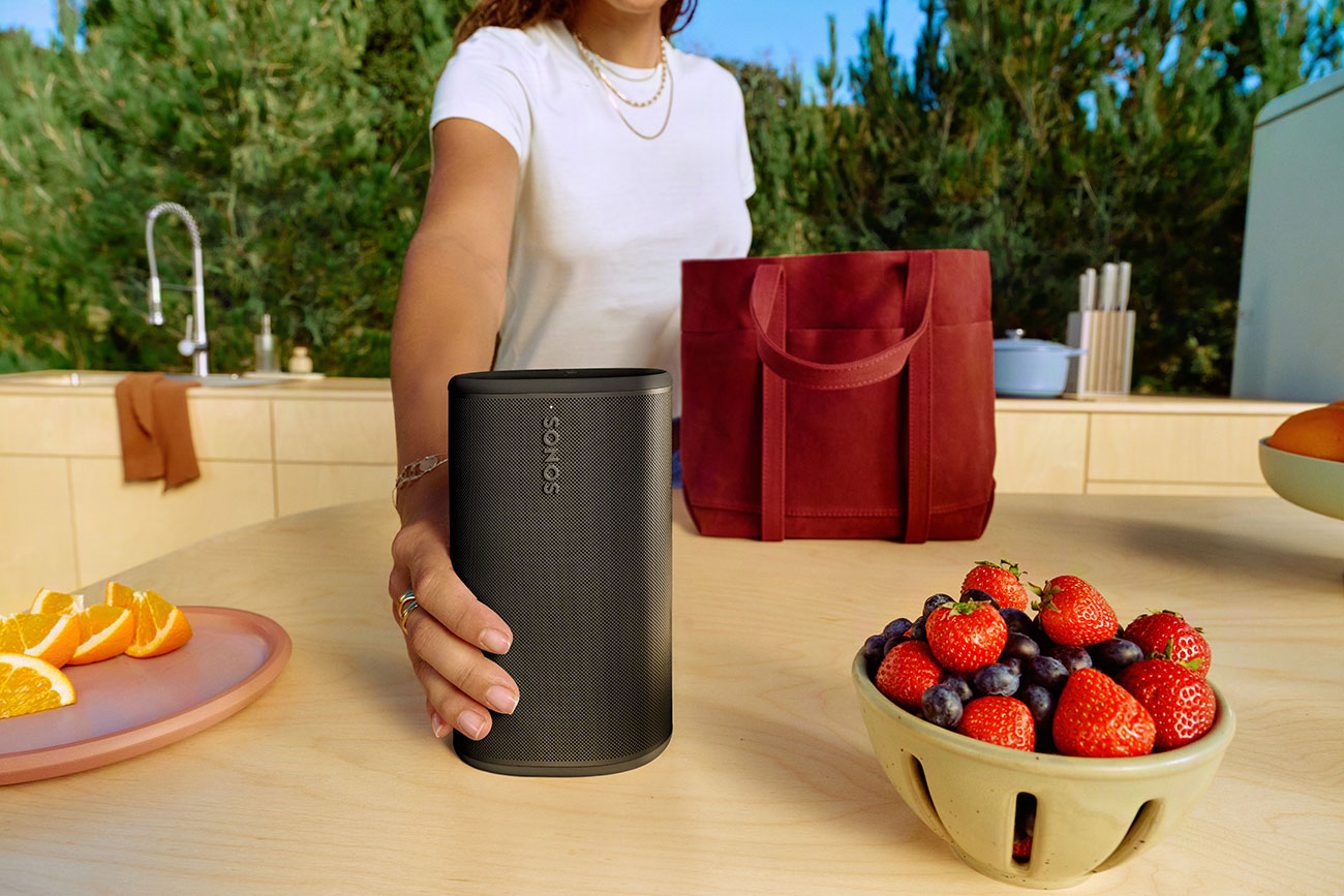Woman Using Sonos Wireless Speaker Outdoors