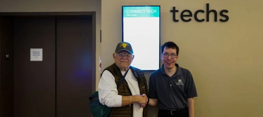 Jim Weinstein wearing a Vietnam veteran hat and shaking hands with Jordan from our Connect store for the Customer Appreciation Sale