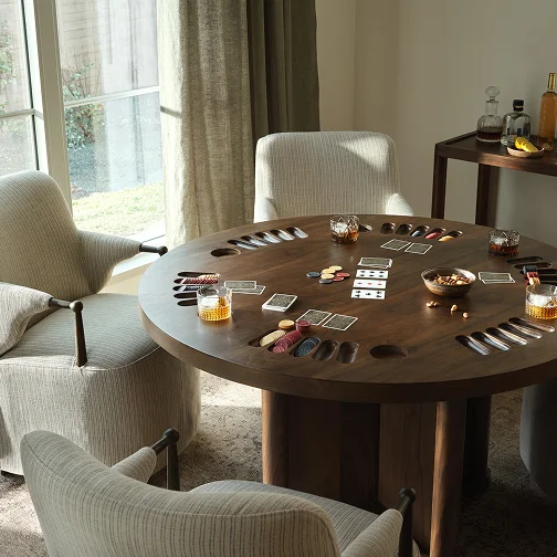 A game room table displaying a card game with a chair positioned next to it.
