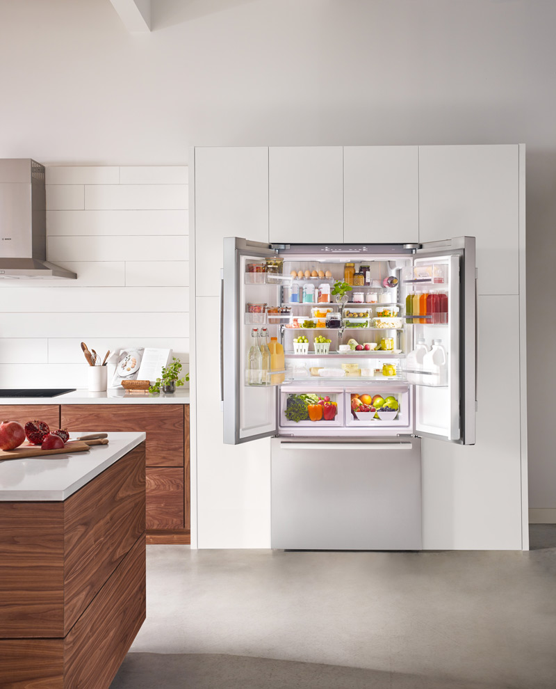 Bosch 800 Series 36 Inch Counter-Depth Refrigerator Open in a White and Oak Kitchen
