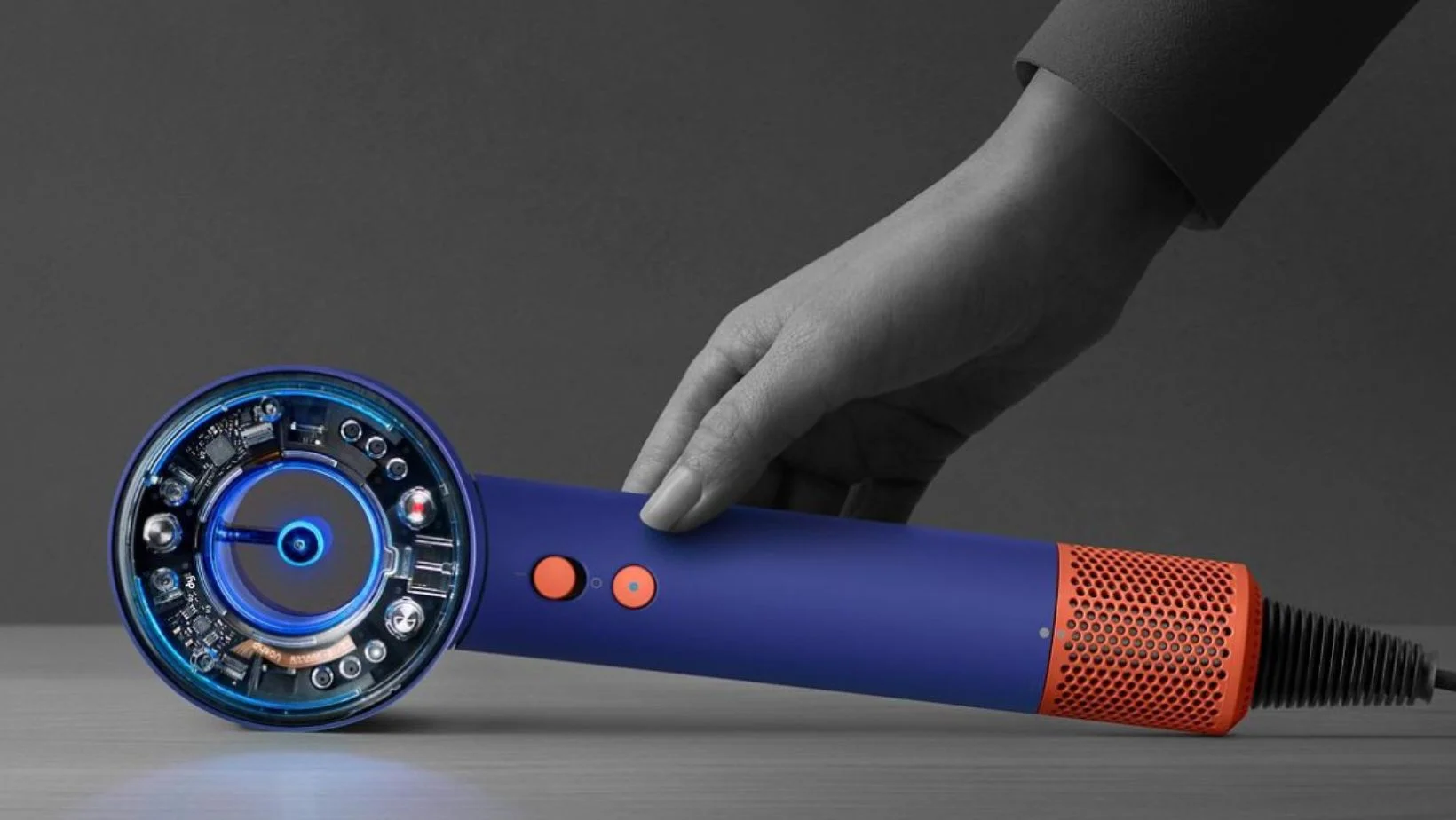 hand setting down Dyson Supersonic Nural on a surface