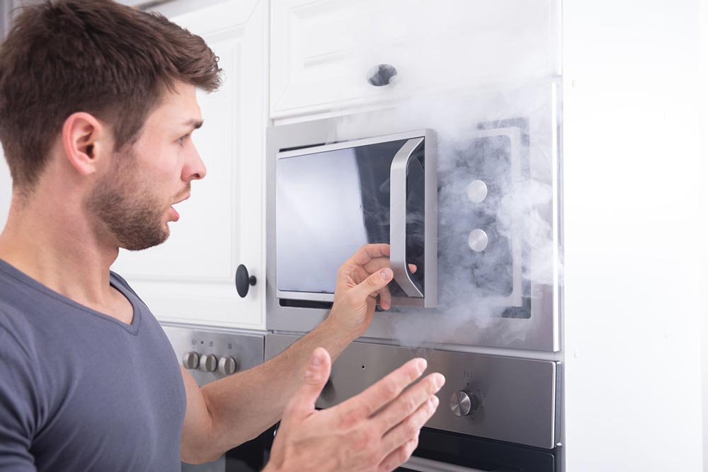 Peson reacting to smoke and odor in an above range microwave