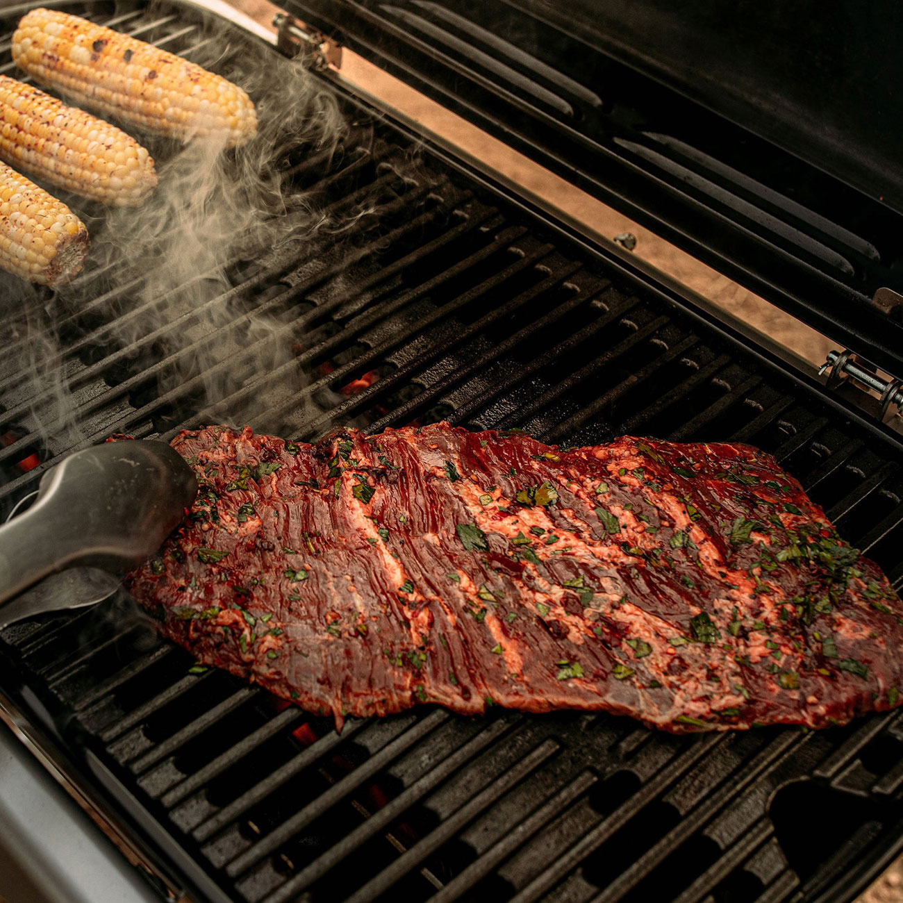 Angled right top view of Weber Traveler Portable Liquid Propane Gas Grill with food