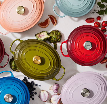 Le Creuset® round Dutch ovens in vibrant colors, highlighting their iconic style and quality