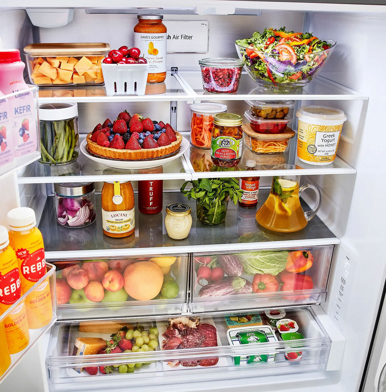 Angled front view inside LG refrigerator full