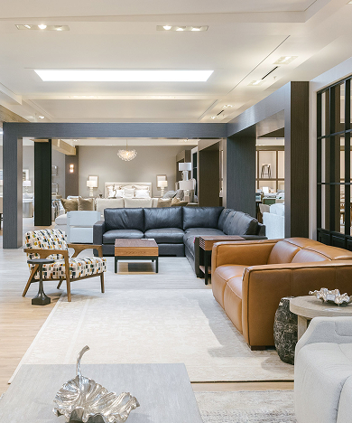 Luxury living room furniture showroom featuring leather seating and designer décor.