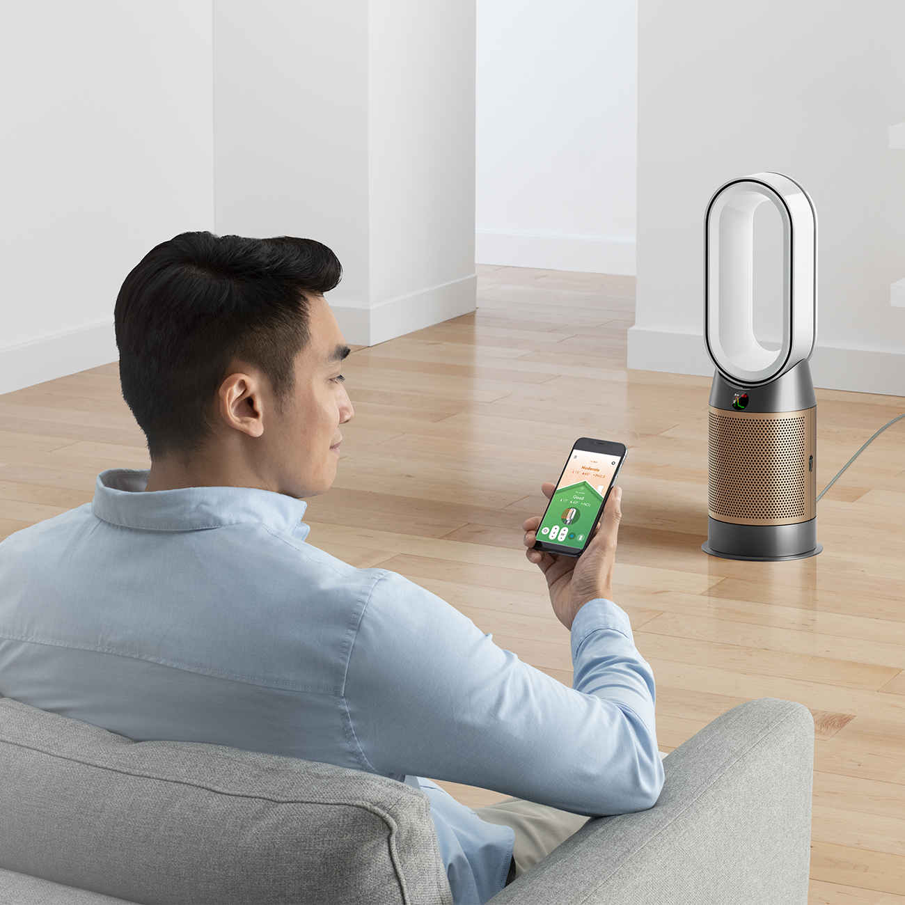 Dyson Air Purifier Managed by a Person Using a Mobile App While Sitting on a Couch
