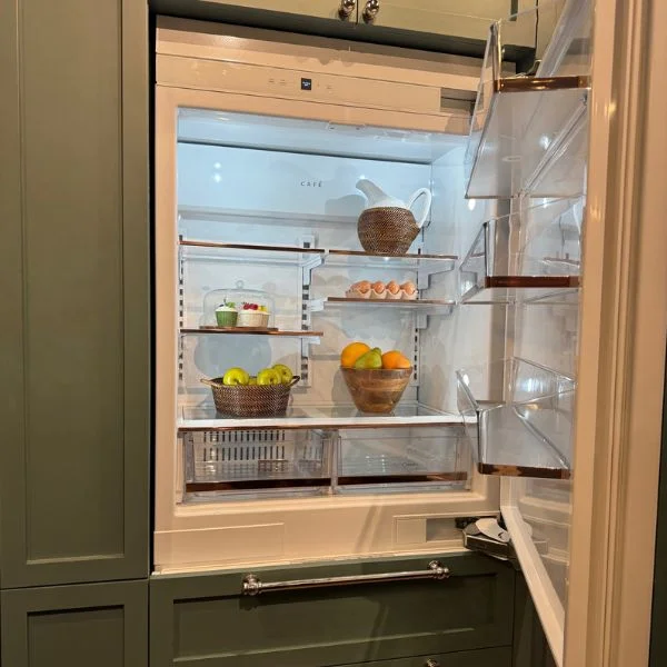 Interior shot of a Cafe French door refrigerator with green panel design.