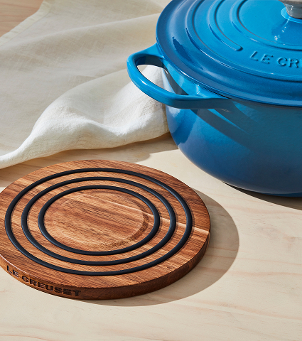 a trivet next to a dutch oven on a table