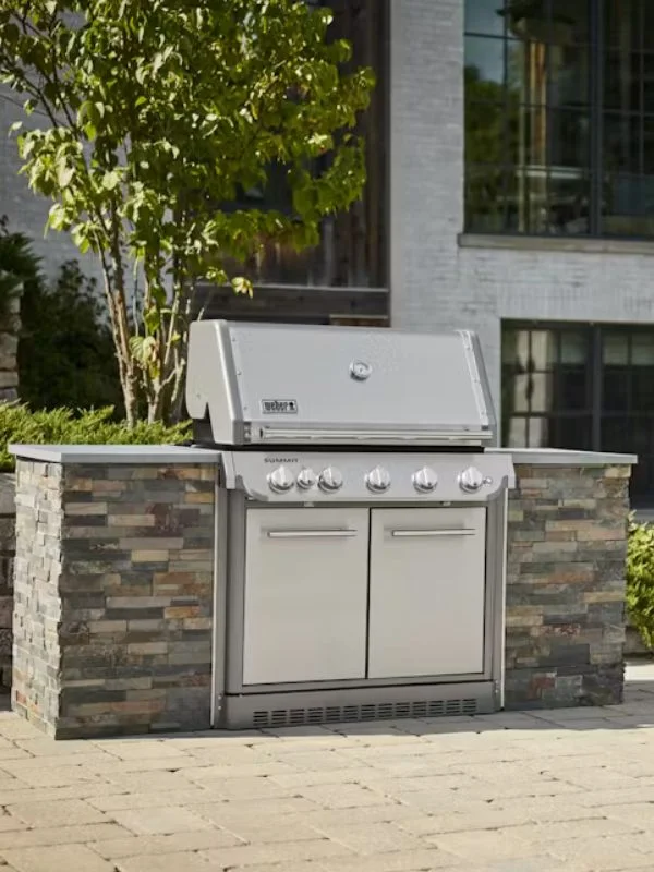 A stainless steel built in weber grill