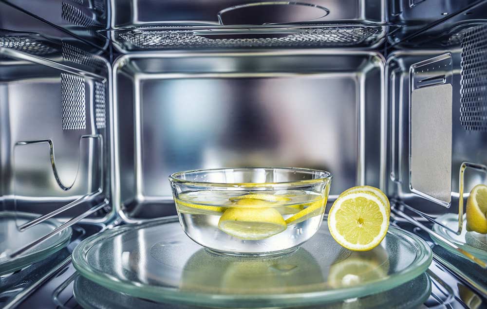 Interrior of bright microwave with lemons and water