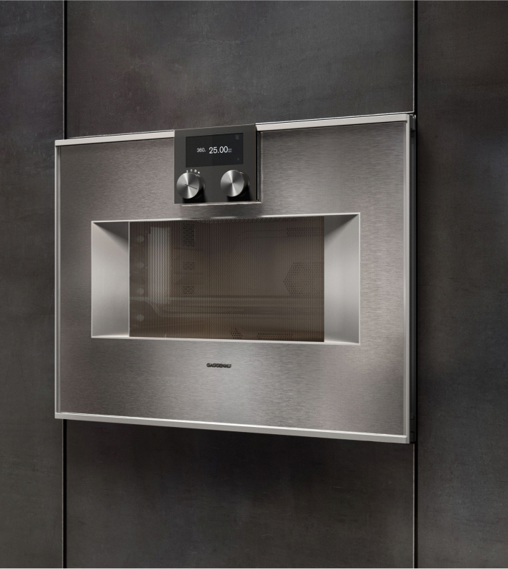 A stainless steel Gaggenau built-in microwave oven featuring a sleek digital display for modern kitchen aesthetics