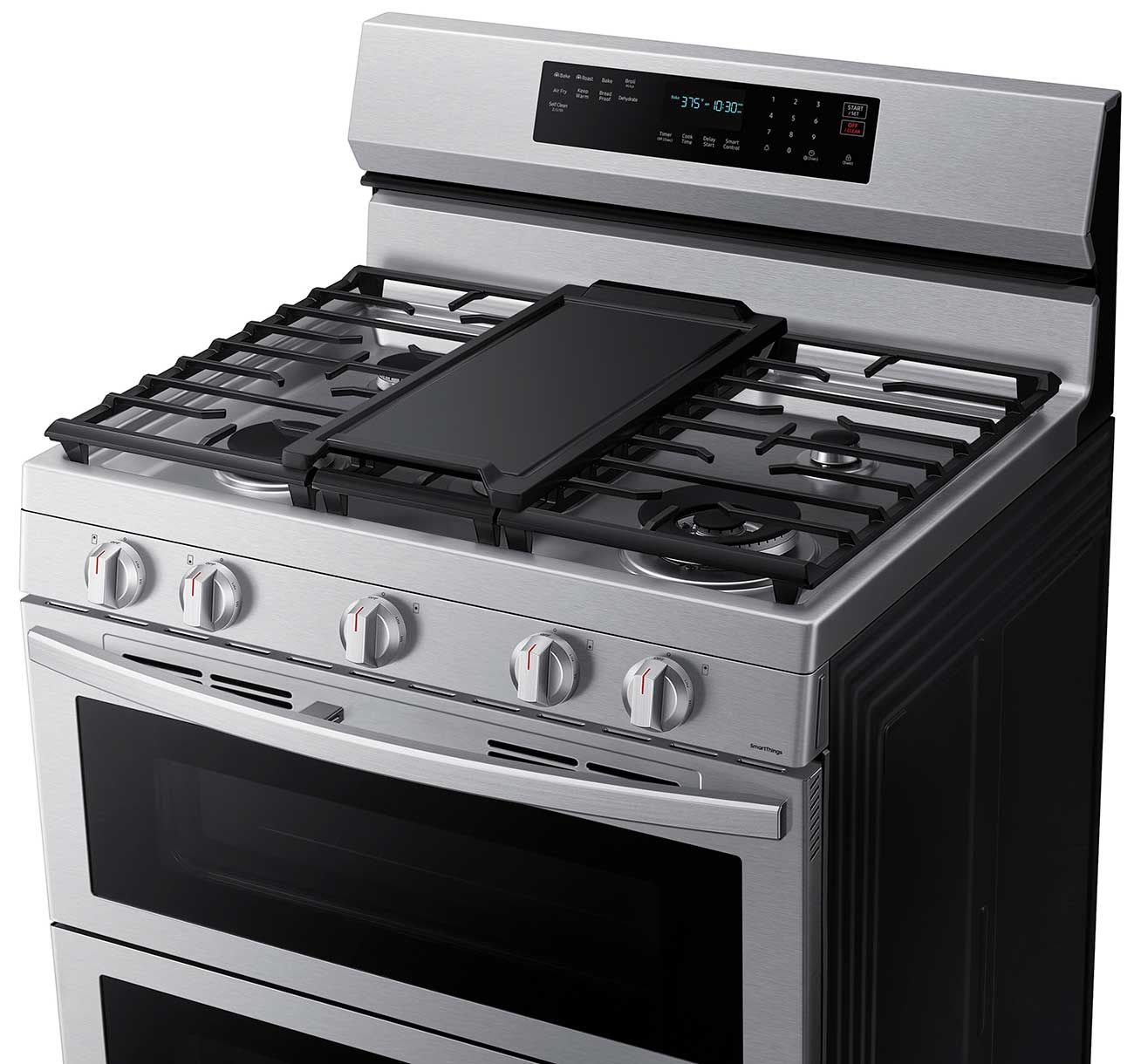Zoomed-in view of cooktop and control knobs.