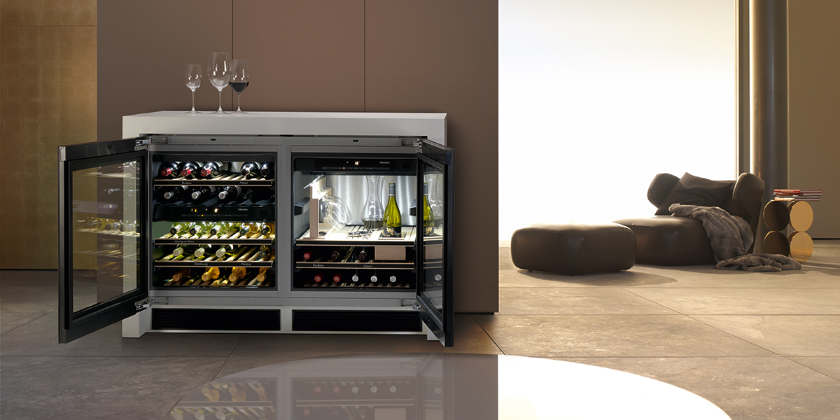 A freestanding wine refrigerator in a home with the doors open to show shelves of wine and wine glass storage