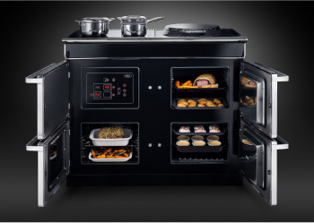 Detailed view of a black Aga induction range, featuring food cooking on the stove top, highlighting its modern aesthetic