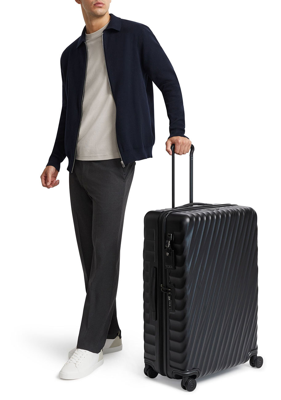 View of model wheeling the TUMI Packing Case