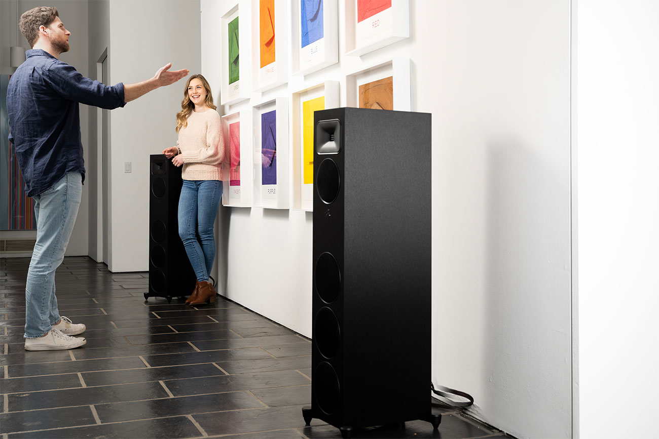 Front View of People Listening to the Martin Logan Speaker in Living Room